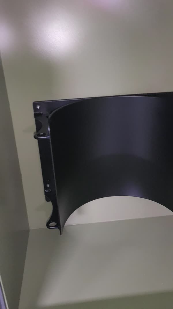 Black powder-coated fender against a green trailer body