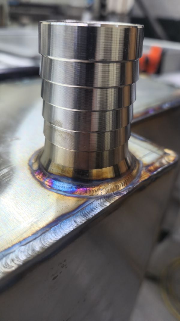 Stainless hose barb TIG welded to a tank