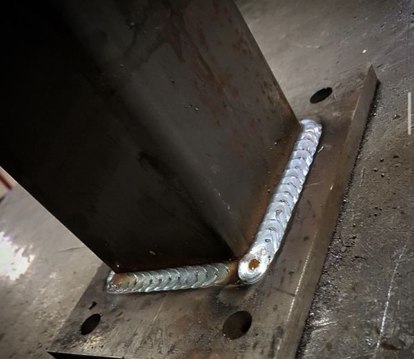 Fillet weld joining a steel post to a base plate